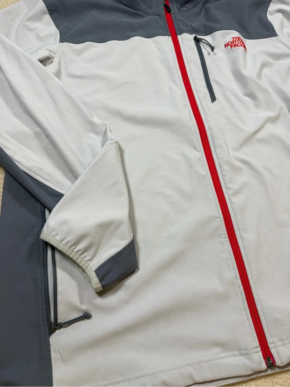 The North Face Men’s Gray Jacket with Red Zipper
